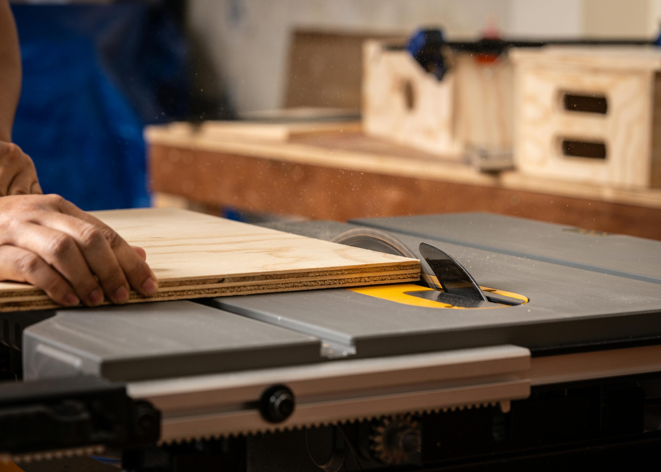 This image depicts a sheet of plywood being cut.