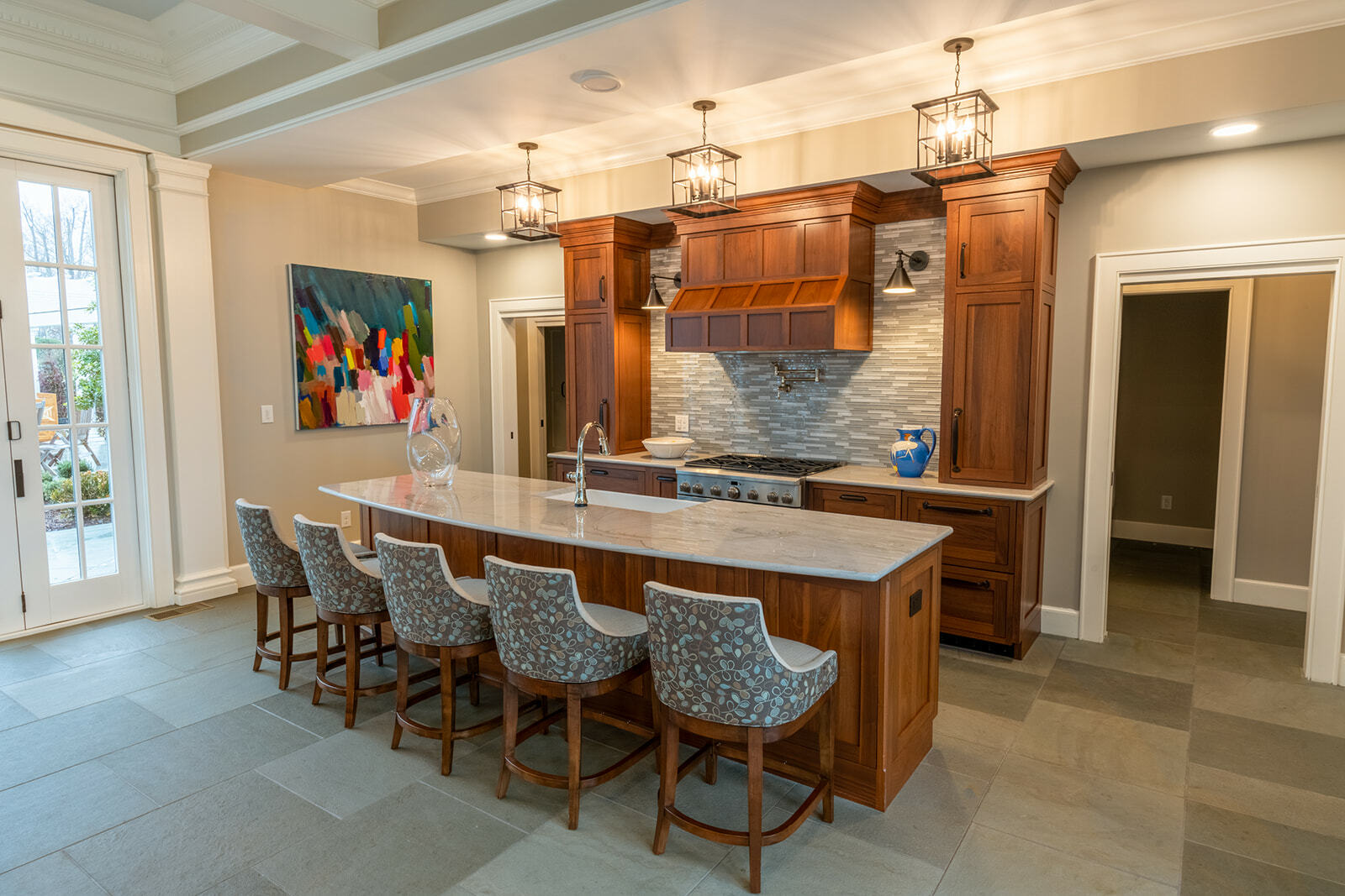  A kitchen has stunning wooden cabinets and quartzite countertops to create a classic design.