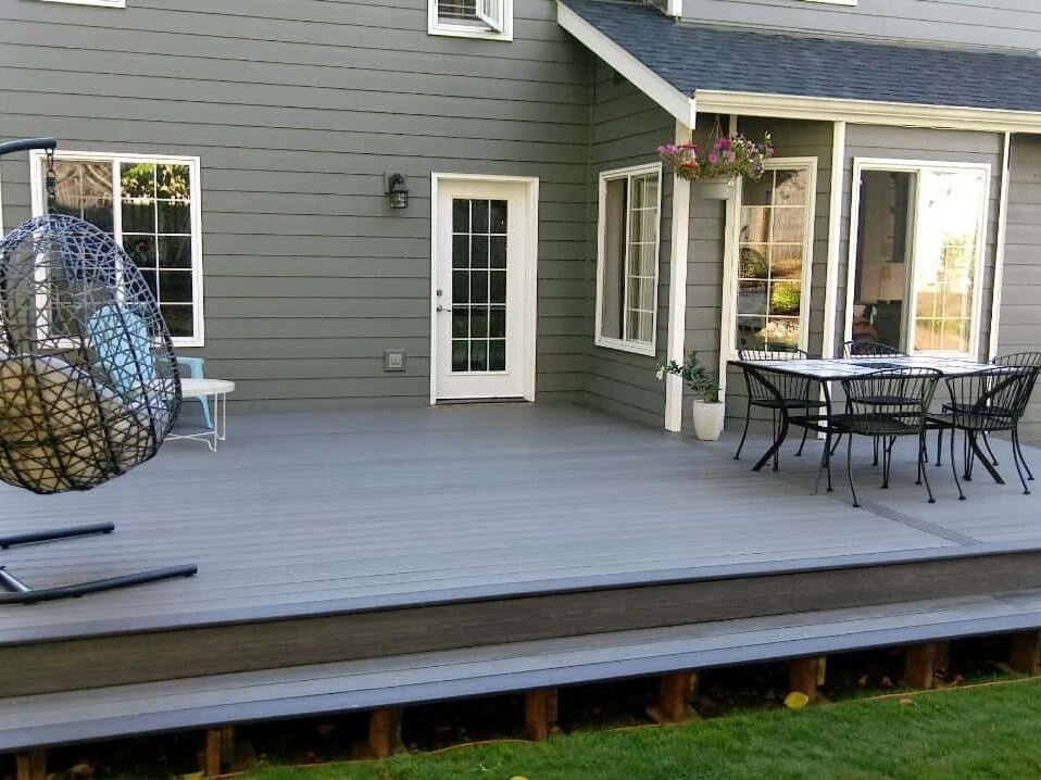 This deck features composite boards, an eating space and a lounging area.