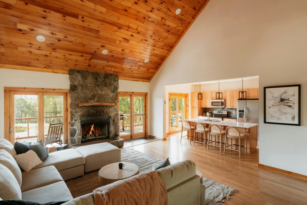 A spacious open-plan lounge and kitchen area with a vaulted ceiling.